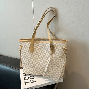 Retro geometric pattern tote bag with small pouch shown on a leather bench