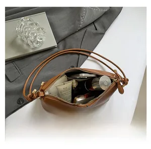 Detail view of large brown lychee grain leather tote showing spacious inner capacity
