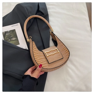 Detail of camel crescent shoulder bag with crocodile texture and gold metal buckle