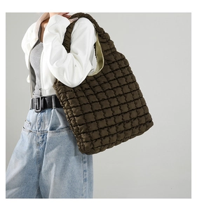Detail of soft quilted texture on dark brown large capacity tote shoulder bag