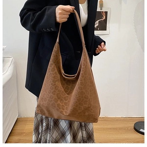 Close-up of brown leopard print hobo shoulder bag in soft faux suede material