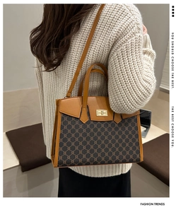 Close-up of vintage monogram canvas tote with leather trim and gold twist-lock closure