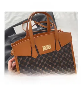 Detail of vintage canvas tote with gold twist lock and brown leather trim accents