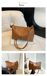 Close-up of brown pebbled leather tote bag featuring a decorative knotted shoulder strap