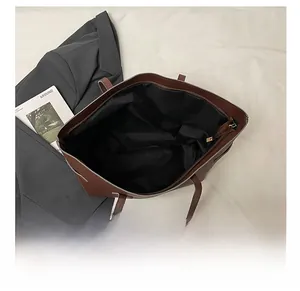 Top view of spacious brown tote bag interior with zipper closure and black lining