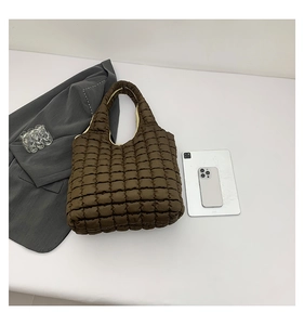 Detailed top view of large brown quilted tote bag with soft bubble texture and glossy finish