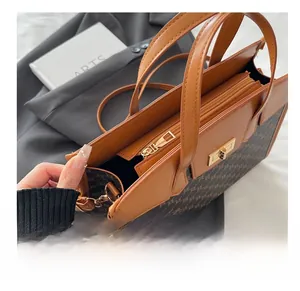 Detailed close-up of the smooth metal zipper and leather trim on the vintage tote bag