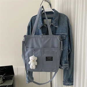 Blue canvas tote bag with adjustable strap and cute bear charm for daily casual commute