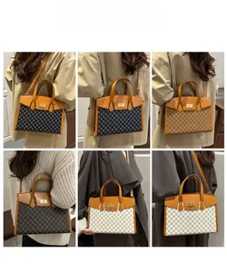 Detail view of model wearing vintage pattern crossbody bags with metal lock in three colors