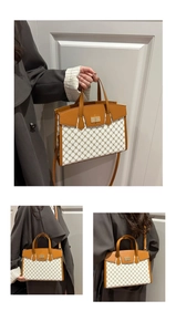 Detail of retro canvas handbag showing brown leather trim and metal twist lock closure