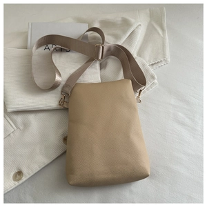 Detailed macro view of the lychee grain faux leather texture and adjustable strap buckle