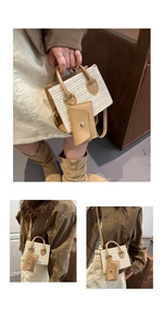Detail of woven straw tote bag with brown PU leather handles and hanging coin purse pouch