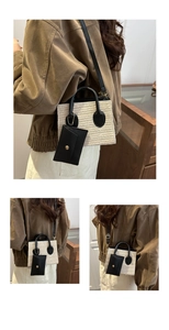 Macro detail of straw woven tote with black leather trim and mini pouch accessory