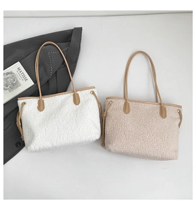 Flat lay of plush lamb wool tote bags in white and oatmeal with leather straps