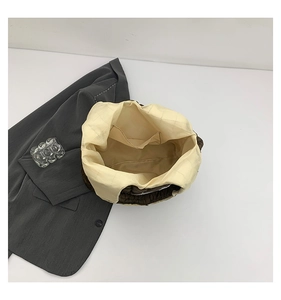 Interior view of tote bag showing beige checkered lining and open inner storage pocket
