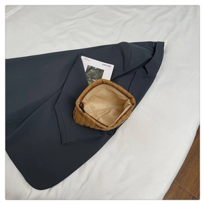 Detail view of large brown quilted clutch with zip opening and light-colored lining