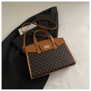 Detail of vintage monogram bag with brown leather trim and golden square swivel lock