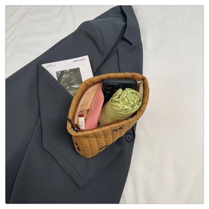 Detail of caramel quilted pouch showing large capacity for phone, umbrella, and cosmetics