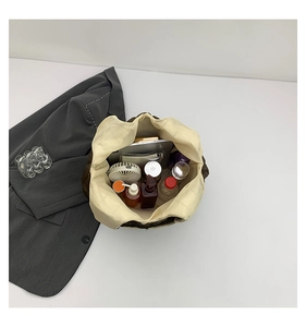 Top view of large quilted brown tote bag showing spacious interior with daily essentials