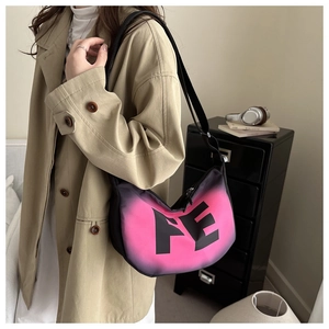 Detail of pink and black gradient half-moon bag with FE lettering on adjustable strap