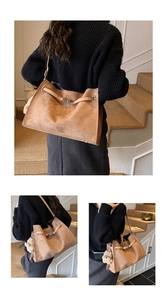 Detail of brown faux suede tote bag featuring a metal buckle and plush bear charm
