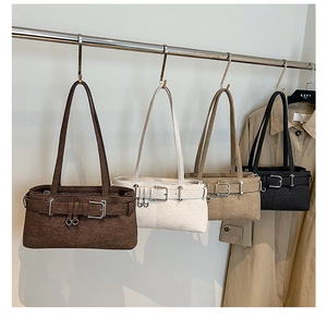 Detail of four textured fabric shoulder bags in brown, beige, khaki, and black colors