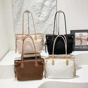 Large plush tote bags in white black and mocha brown displayed on white pedestals