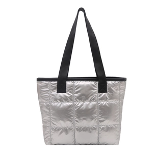 Silver quilted tote bag with black straps and glossy finish for women in autumn winter