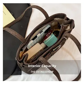 Detail shot of textured brown tote bag interior with pockets and daily essentials