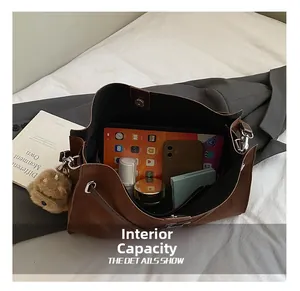 Brown leather tote interior showing large capacity for iPad, phone and cosmetics