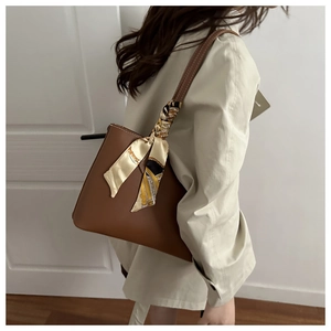 Brown tote bag with printed silk scarf detail shown on shoulder for daily commute