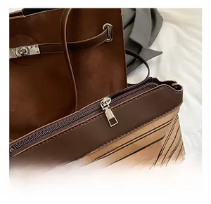 Detailed macro view showing premium metal twist lock and stitching on brown suede tote bag