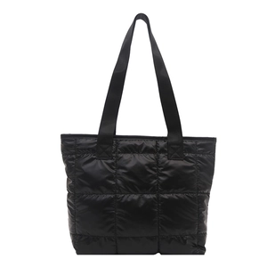 Minimalist black quilted tote bag with shiny nylon finish and large capacity shoulder straps