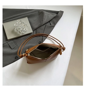 Interior view of caramel brown leather shoulder bag showing the pocket and zip closure
