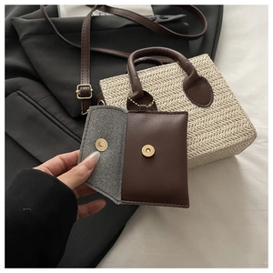 Detailed view of the dark brown mini leather pouch with magnetic closure and gold ball chain