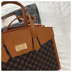 Detail of vintage monogram shoulder bag with leather trim and gold twist-lock closure