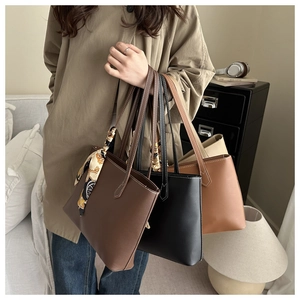 Detail of vintage tote bags in dark brown and black with silk scarf and stitching