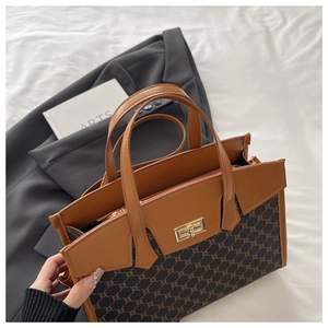 Close-up of retro canvas tote bag with brown leather trim and golden twist lock