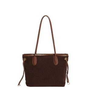 Brown fuzzy plush tote bag with leather trim and shoulder straps for winter fashion