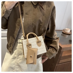 Detail of straw woven crossbody bag with detachable khaki leather coin purse on olive jacket