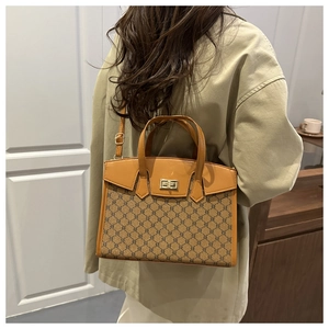 Detail of vintage retro crossbody bag with classic pattern stitching and gold metal lock