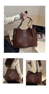 Detail view of large dark brown leather tote bag with metallic logo and model shoulder wear