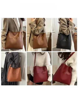 Three minimalist tote bags in brown black and burgundy with adjustable straps shown on models