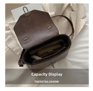 Détail de la capacité intérieure du sac à bandoulière marron vintage avec fermoir