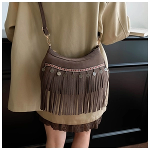 Brown suede crescent bag with vintage tassels and ethnic embroidery on model back