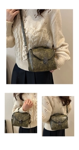 Detail view of olive green retro crossbody bag with vintage crackle texture and metal lock