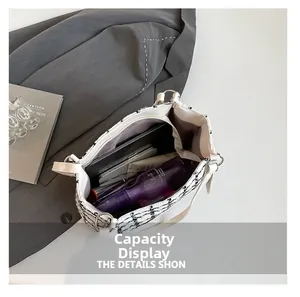 Interior view showing the large capacity of a tweed tote bag with essentials and tablet