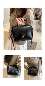 Detail of vintage oil wax leather square bag featuring silver rotary buckle and handle