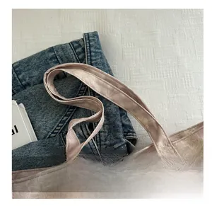 Detailed close-up of light pink floral canvas tote with reinforced stitched handles