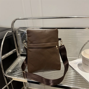Deep brown lychee pattern mini crossbody bag with wide nylon strap and gold hardware